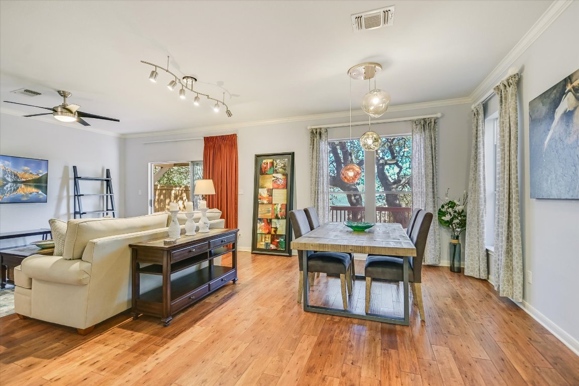 7501 Shadowridge Run, Unit 110 Austin, TX 78749 - Photo 19 of 20 The downstairs features oak flooring and an airy, open floor plan with designer lighting.