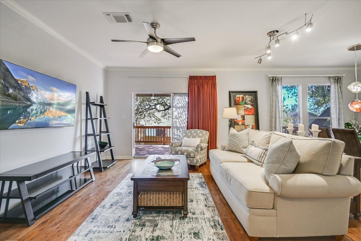 7501 Shadowridge Run, Unit 110 Austin, TX 78749 - Photo 4 of 20 The living room opens to the back deck and is fully equipped with cozy furniture and a TV to watch your favorite show or the big game.