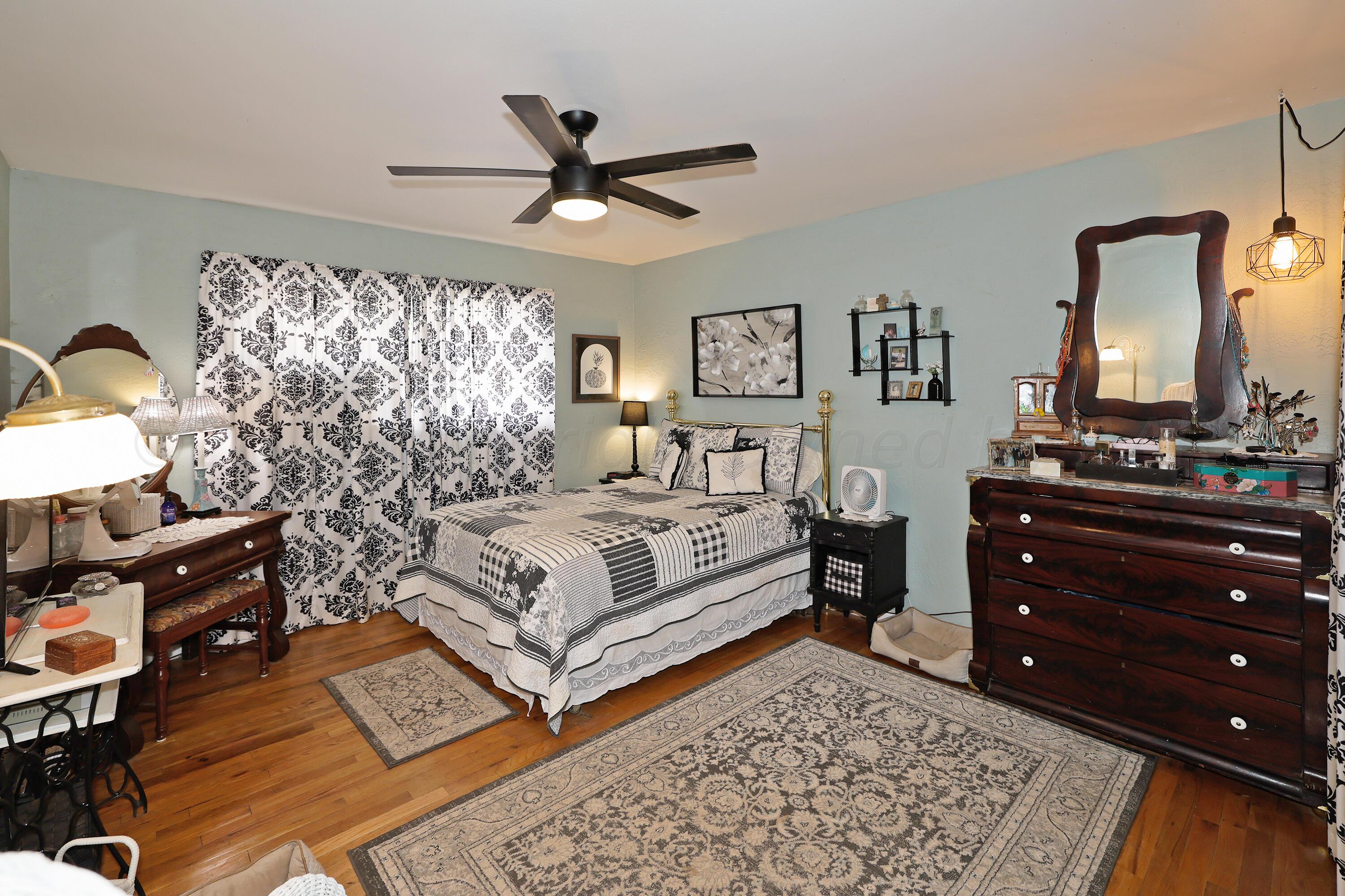 411 North Prospect Street Amarillo, TX 79106 - Photo 11 of 22 a bedroom with a bed and wooden floor