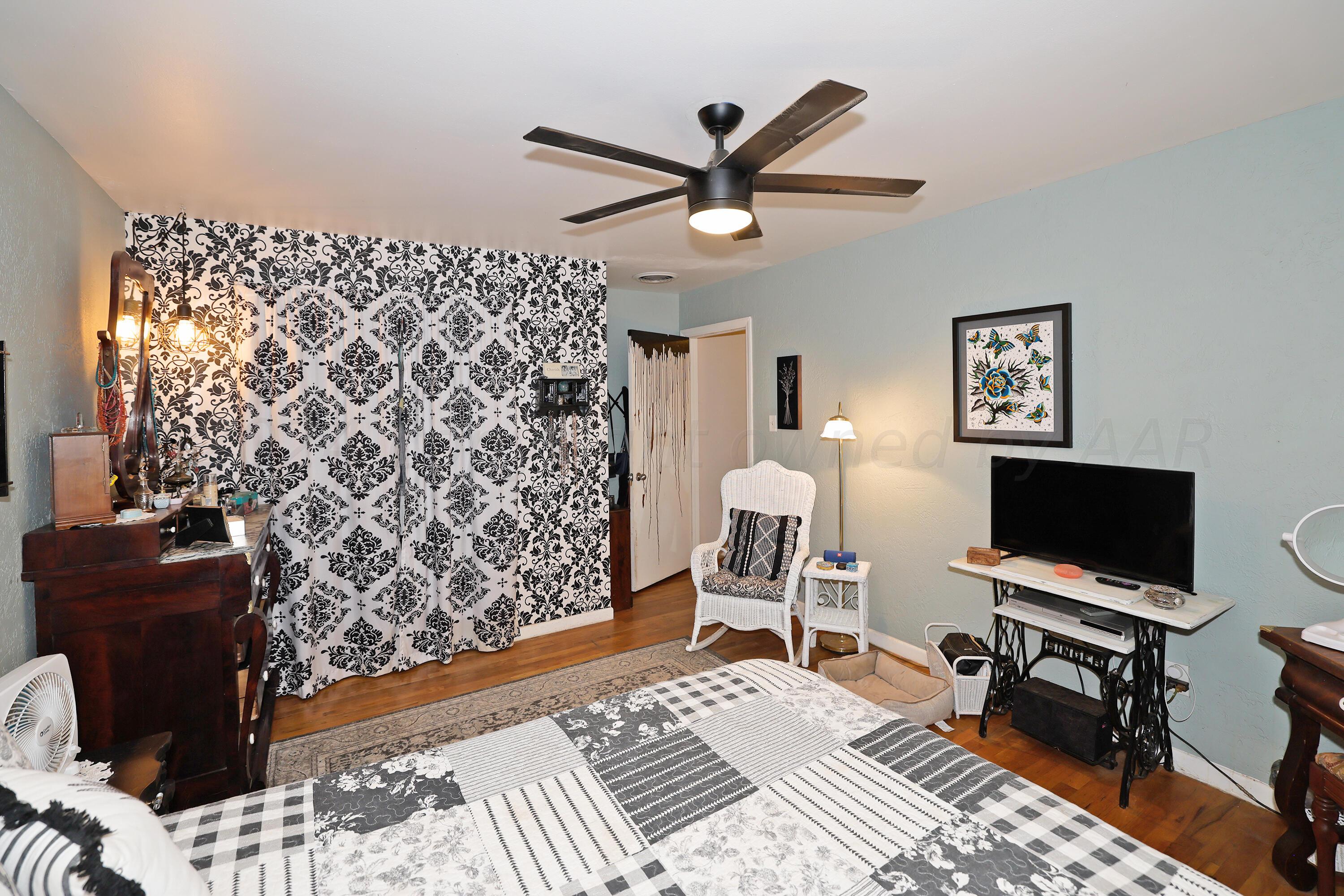 411 North Prospect Street Amarillo, TX 79106 - Photo 12 of 22 a bedroom with a bed and a flat screen tv