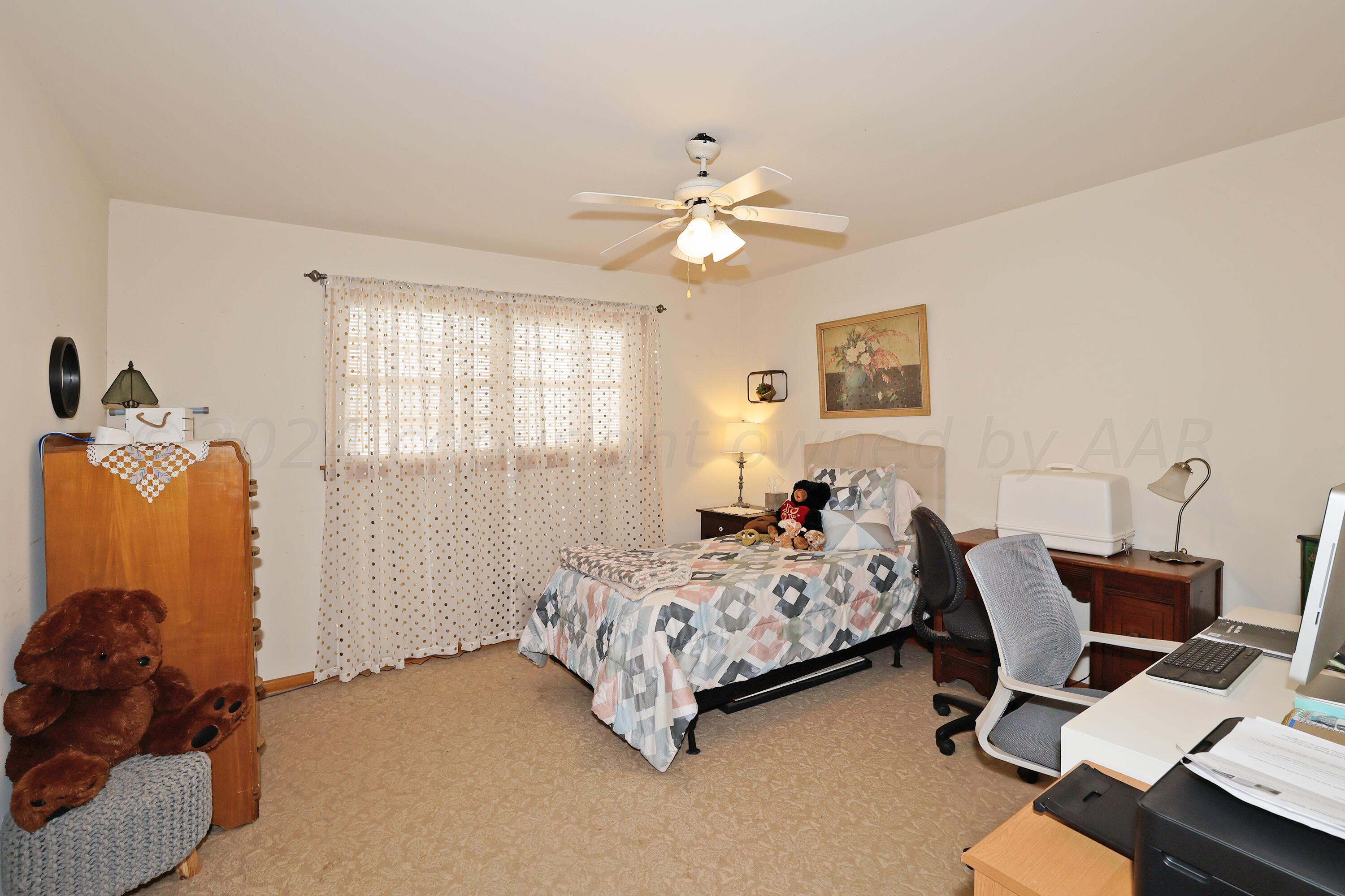 411 North Prospect Street Amarillo, TX 79106 - Photo 14 of 22 a bedroom with a bed and a chandelier