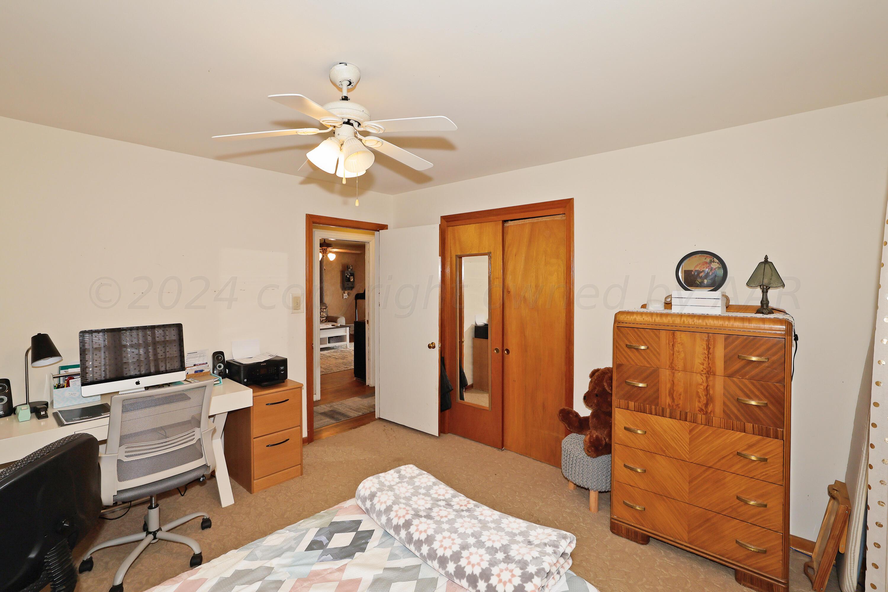 411 North Prospect Street Amarillo, TX 79106 - Photo 15 of 22 a bedroom with a bed and a chandelier
