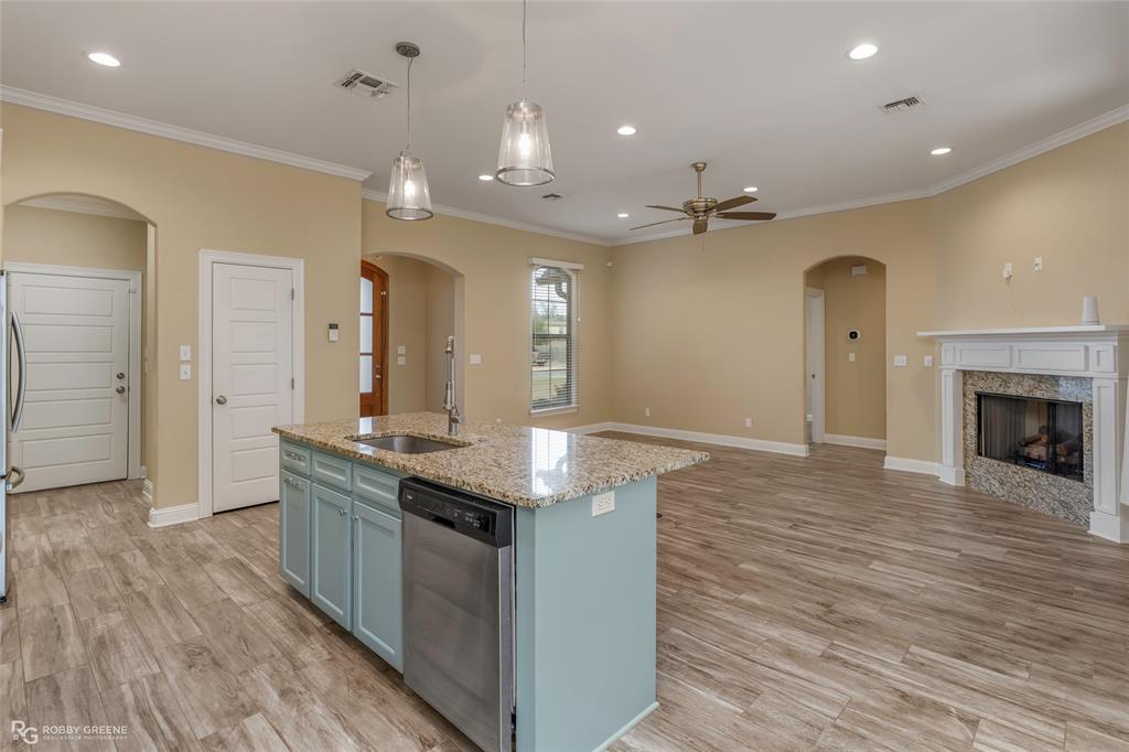 352 Wood Springs Haughton, LA 71037 - Photo 12 of 34 an open kitchen with granite countertop a sink and a fireplace