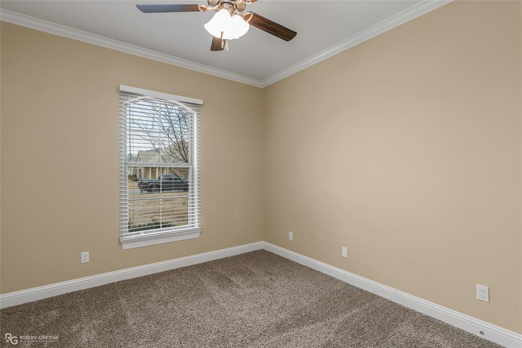 352 Wood Springs Haughton, LA 71037 - Photo 24 of 34 an empty room with a chandelier fan and windows