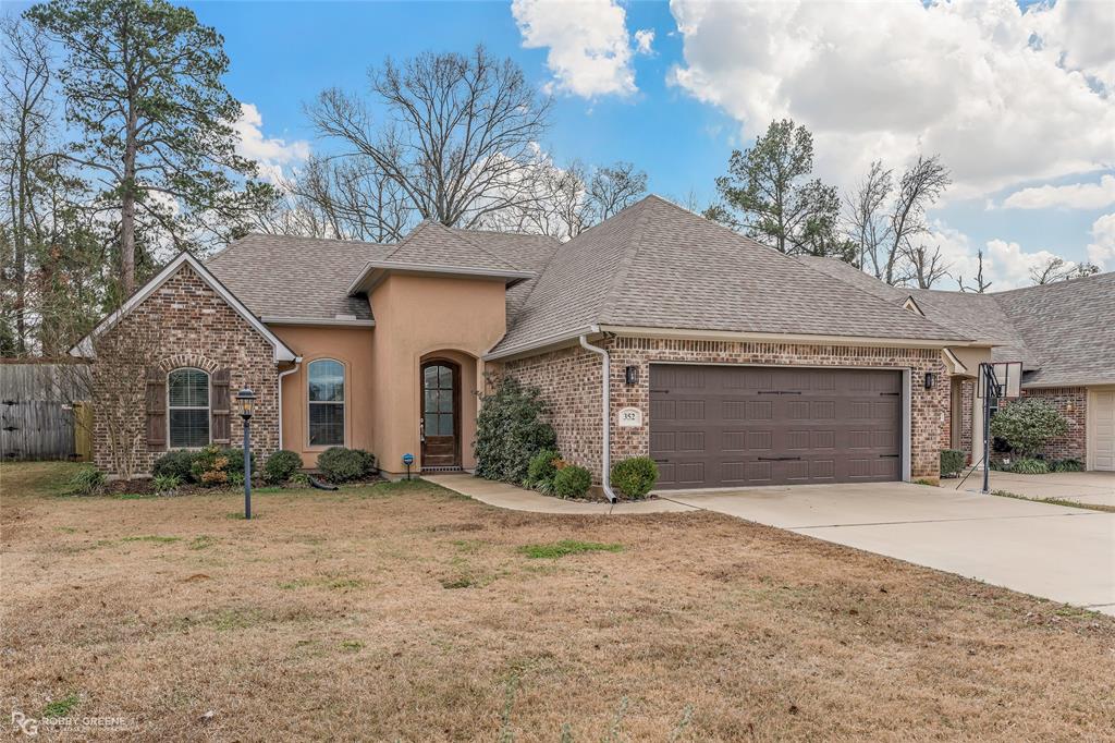 352 Wood Springs Haughton, LA 71037 - Photo 28 of 34 a front view of a house with a yard and garage