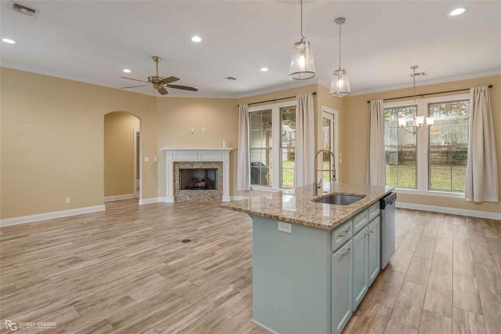 352 Wood Springs Haughton, LA 71037 - Photo 5 of 34 an open kitchen with granite countertop window and wooden floor