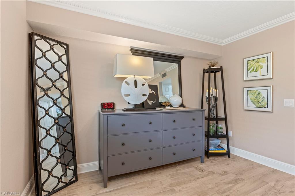 950 7th Avenue South, Unit 23 Naples, FL 34102 - Photo 14 of 40 a room with a dresser and a window