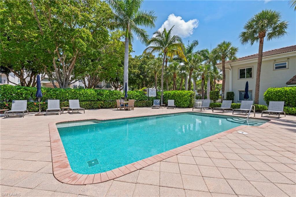 950 7th Avenue South, Unit 23 Naples, FL 34102 - Photo 3 of 40 a view of a swimming pool with a patio