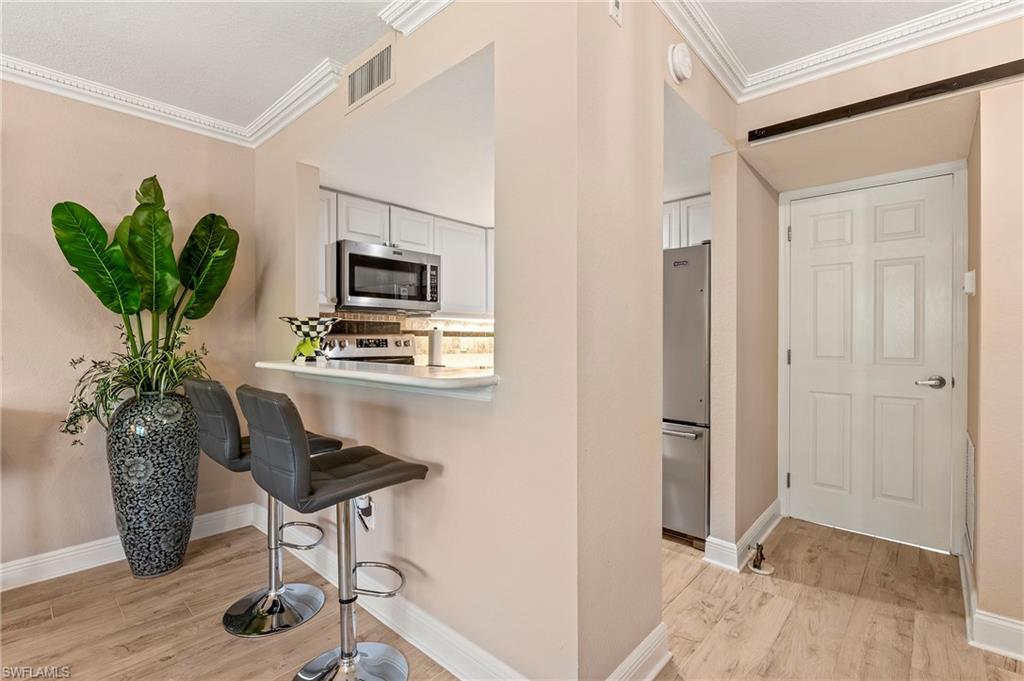 950 7th Avenue South, Unit 23 Naples, FL 34102 - Photo 9 of 40 a living room with furniture and a potted plant