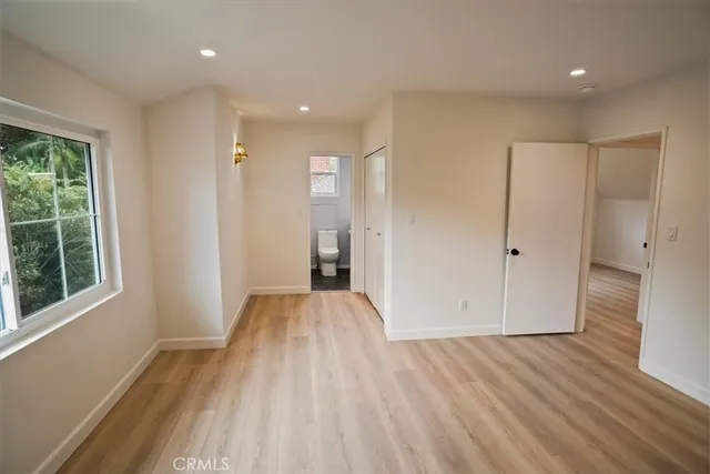 a view of hallway with a large window and wooden floor
