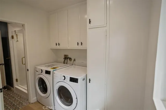 a view of storage and utility room with washer and dryer