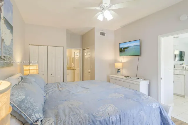 a spacious bedroom with a bed and a chandelier