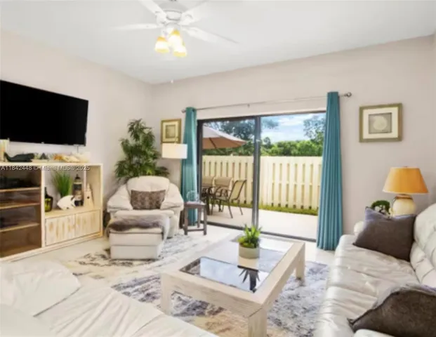 a bedroom with furniture and a large window