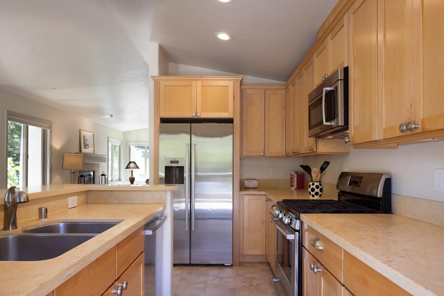 594 Viejo Road Carmel, CA 93923 - Photo 11 of 23 a kitchen with stainless steel appliances granite countertop a sink a stove and a refrigerator