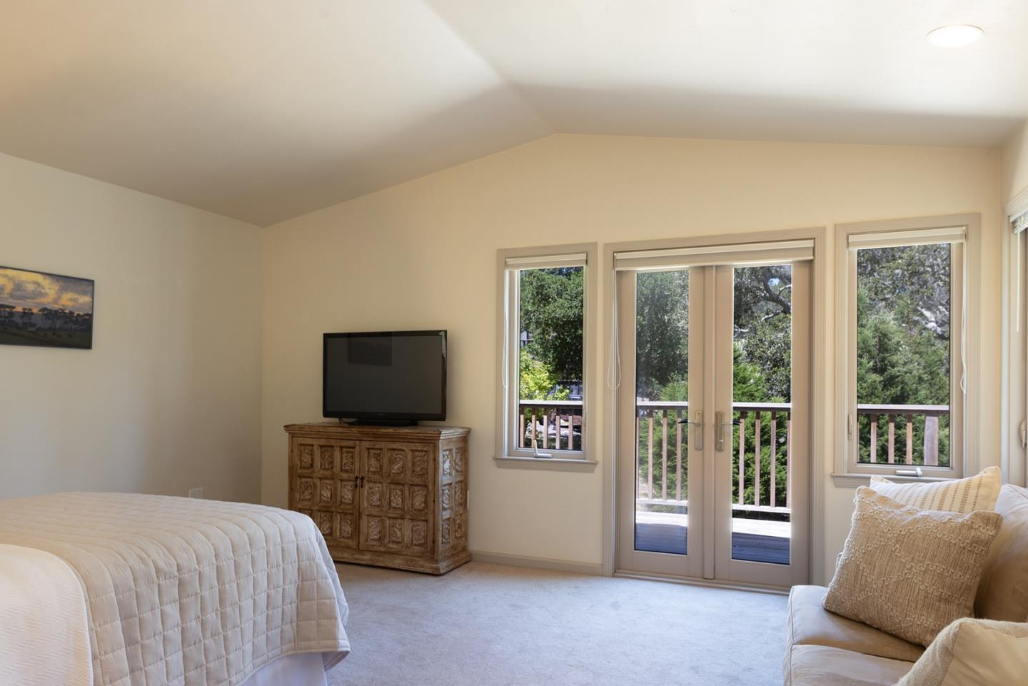 594 Viejo Road Carmel, CA 93923 - Photo 13 of 23 a bedroom with furniture and a flat screen tv