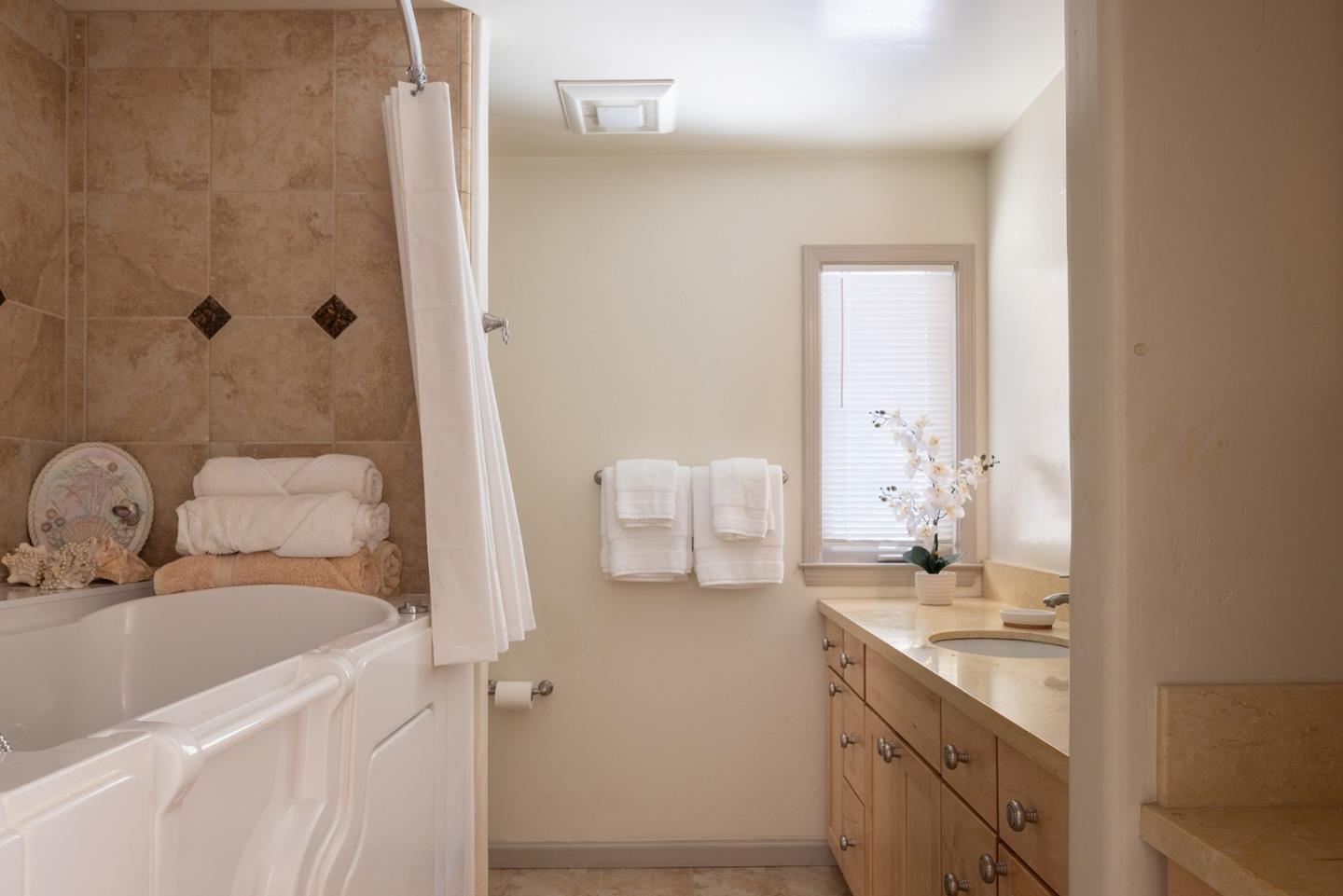 594 Viejo Road Carmel, CA 93923 - Photo 14 of 23 a bathroom with a tub sink and mirror