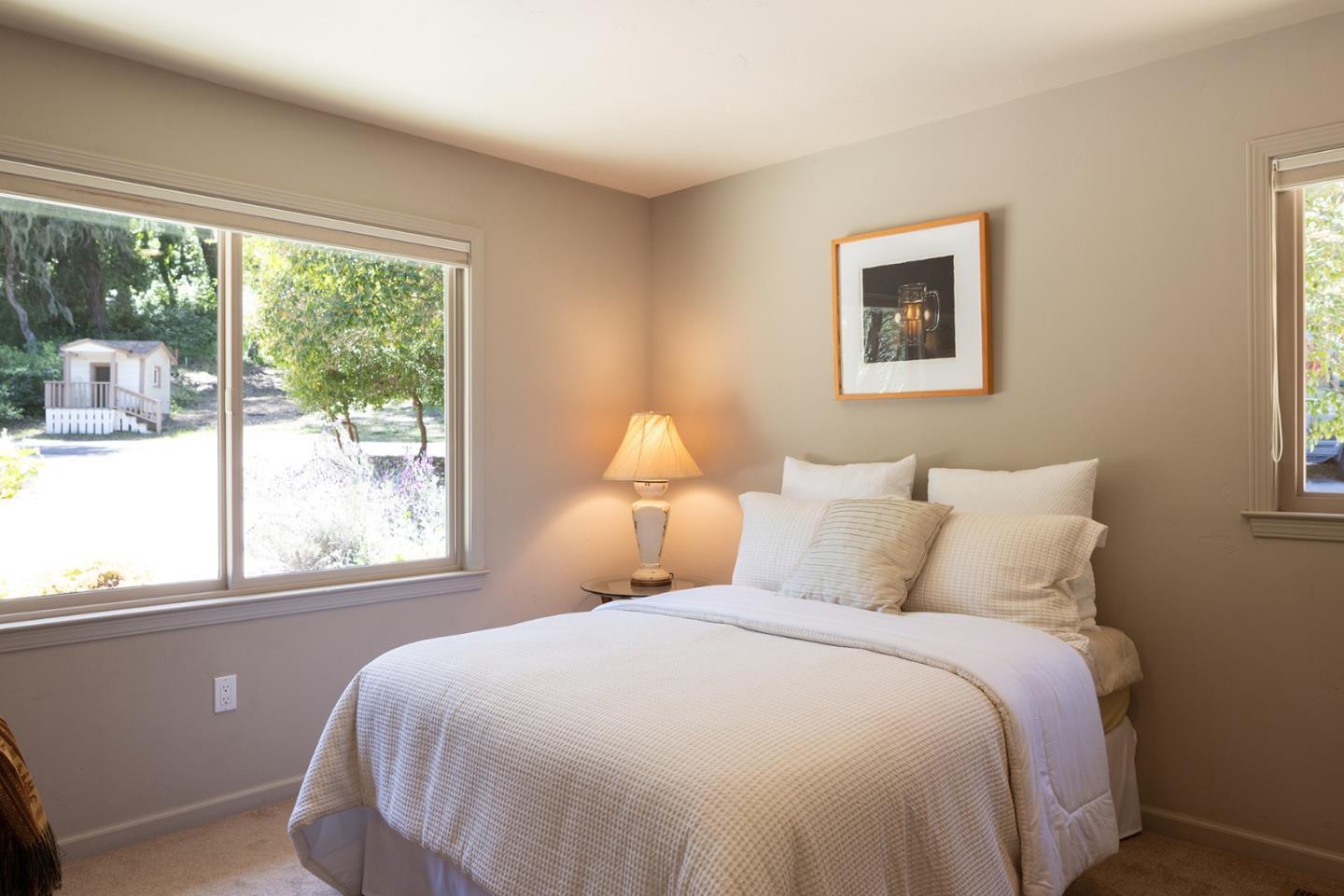 594 Viejo Road Carmel, CA 93923 - Photo 16 of 23 a bedroom with a large bed and a large window