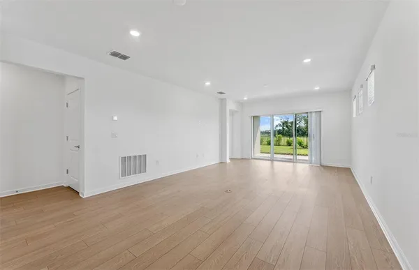 a view of an empty room and wooden floor