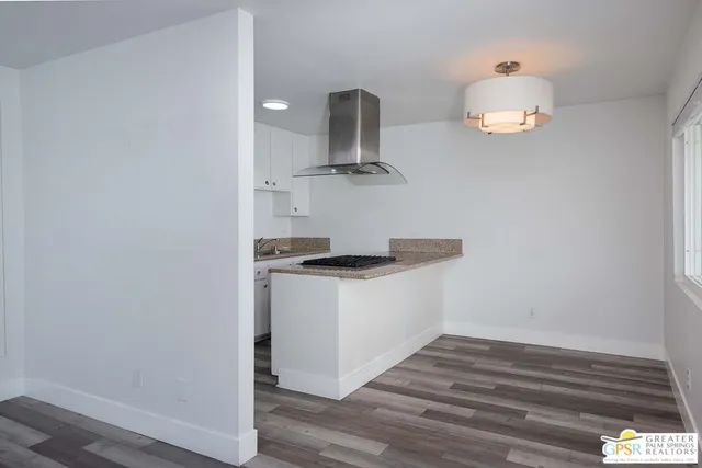 a kitchen with stainless steel appliances granite countertop a sink and a stove