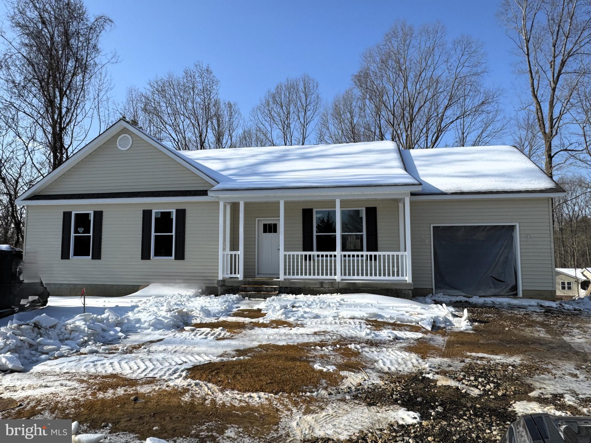 1362 Solomons Island Road Huntingtown, MD 20639 - Photo 1 of 16 a front view of a house with a yard and garage
