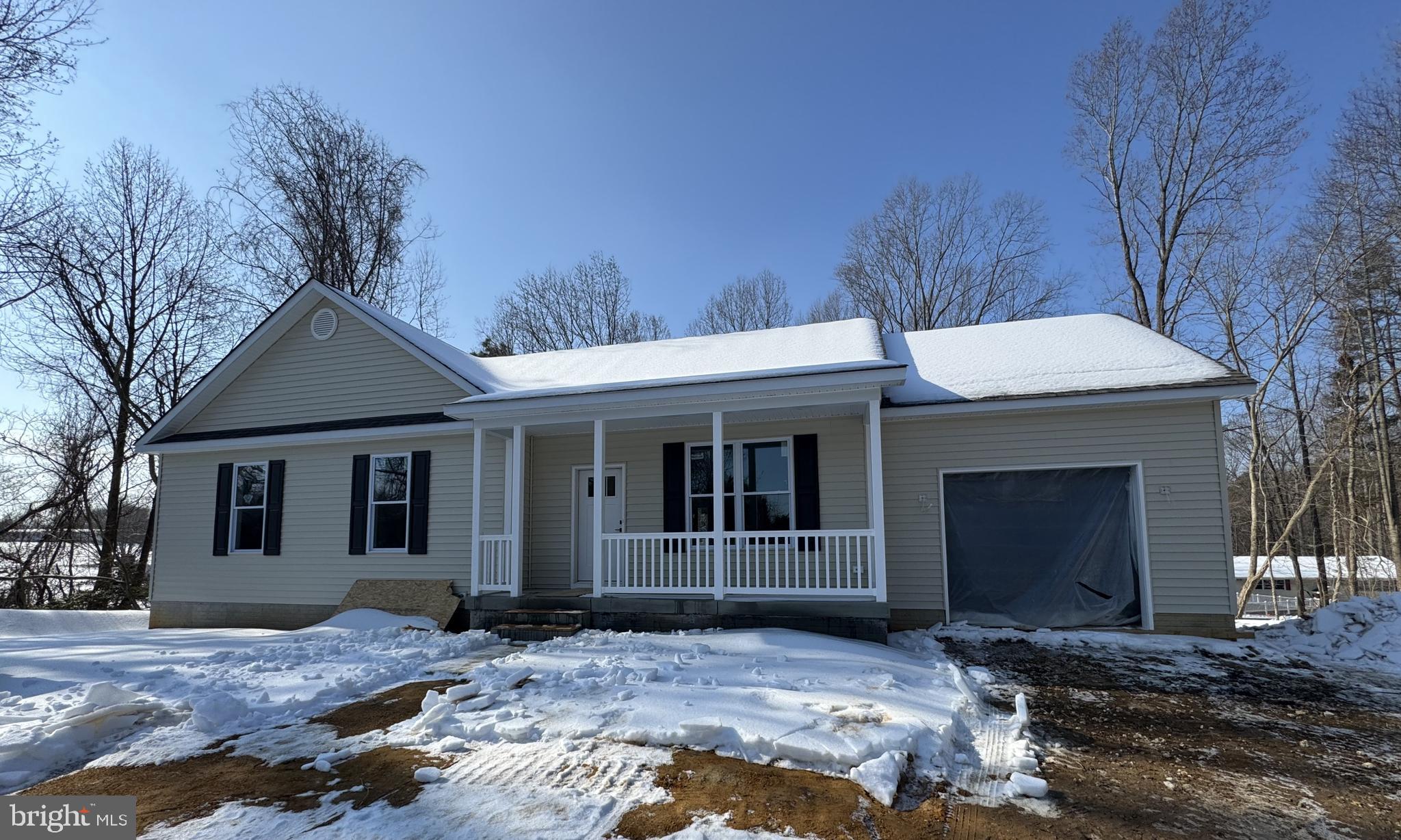 1362 Solomons Island Road Huntingtown, MD 20639 - Photo 16 of 16 a front view of a house with a yard and garage