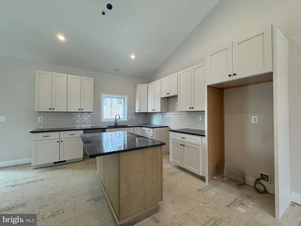 a kitchen with stainless steel appliances granite countertop a refrigerator sink and cabinets