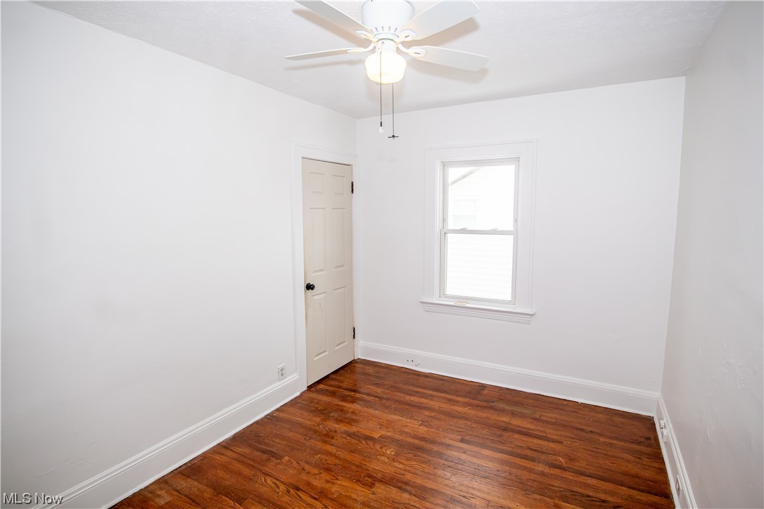16315 Nela View Road Cleveland, OH 44112 - Photo 15 of 24 Unfurnished room featuring dark hardwood / wood-style flooring and ceiling fan
