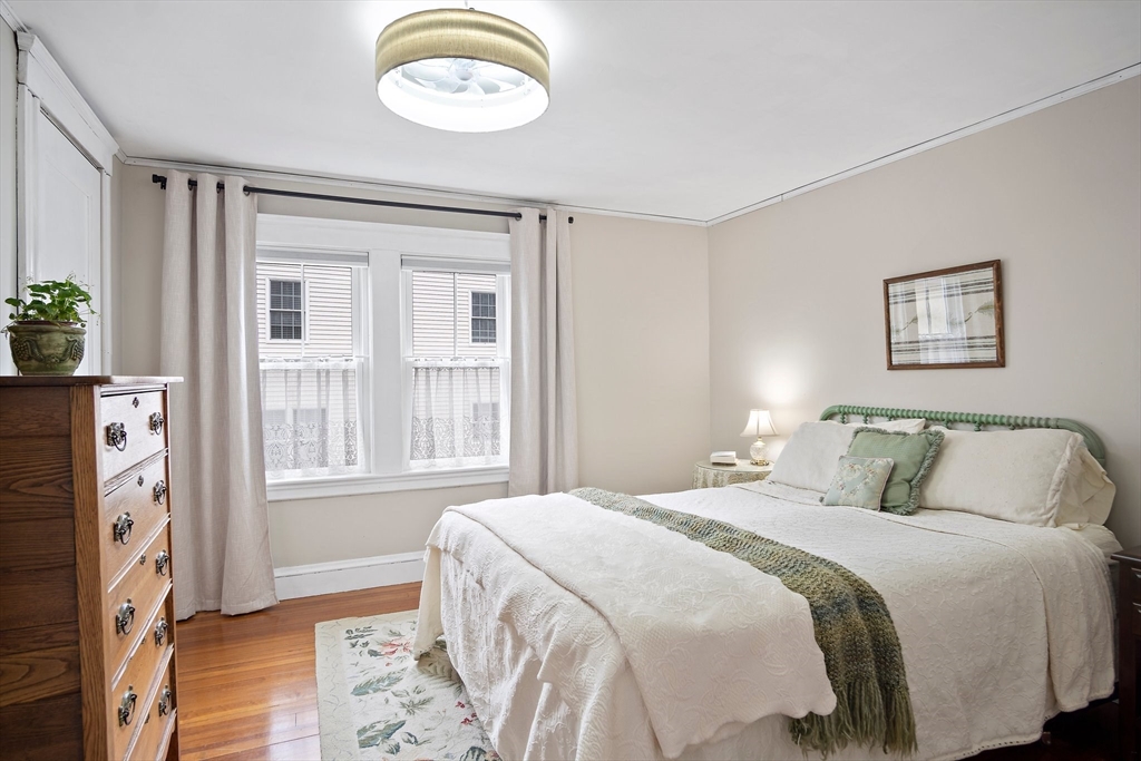 8 Flagg Street Woburn, MA 01801 - Photo 13 of 25 a bedroom with a bed and a chandelier