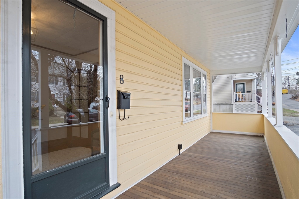 8 Flagg Street Woburn, MA 01801 - Photo 2 of 25 a view of a hallway with wooden floor and a bathroom