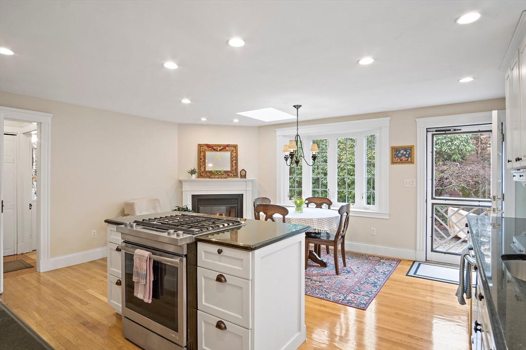 8 Flagg Street Woburn, MA 01801 - Photo 4 of 25 a kitchen that has a stove a table and chairs in it