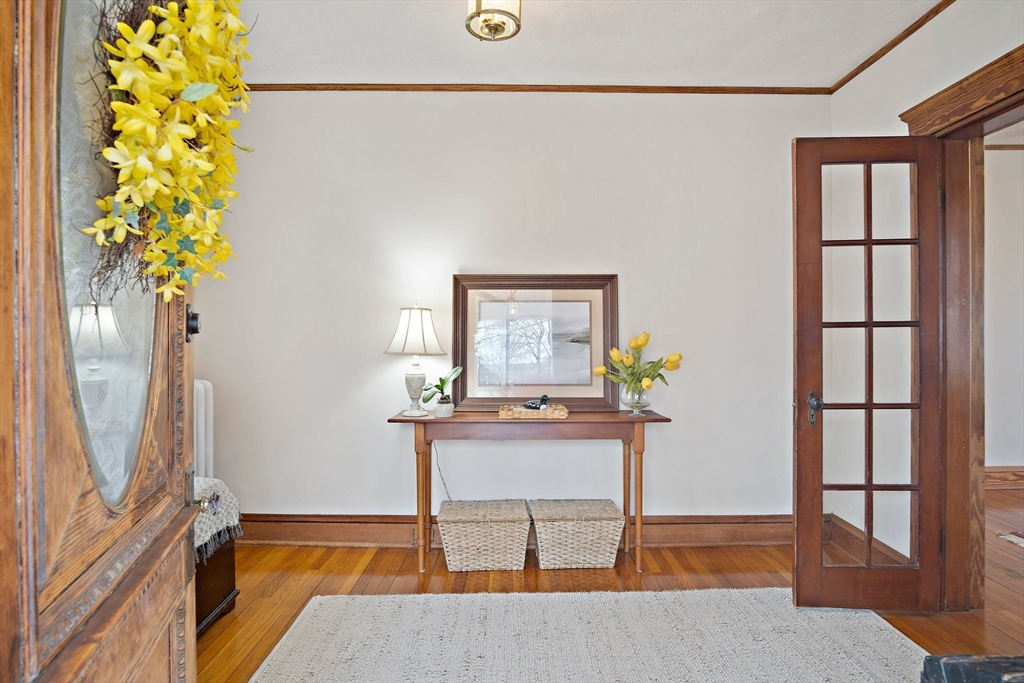 8 Flagg Street Woburn, MA 01801 - Photo 7 of 25 a view of a hallway with wooden floor and a potted plant