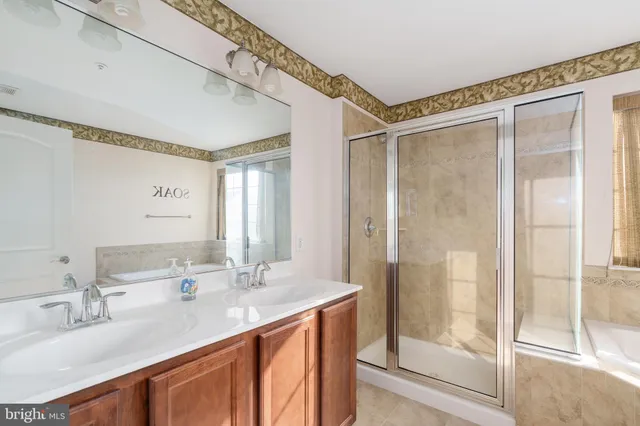 a bathroom with a granite countertop sink mirror and double
