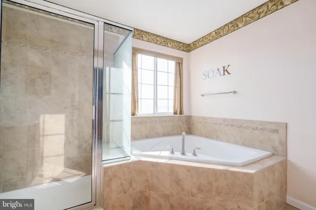 a white bath tub sitting next to a shower