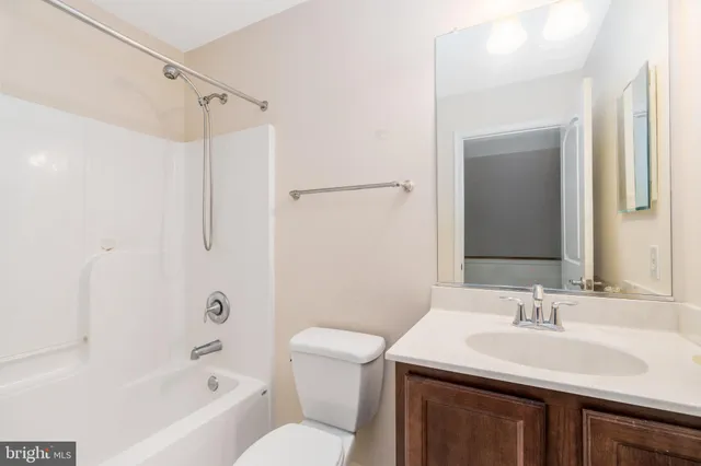 a bathroom with a sink toilet vanity and shower