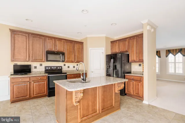 a kitchen with stainless steel appliances a stove sink microwave and cabinets