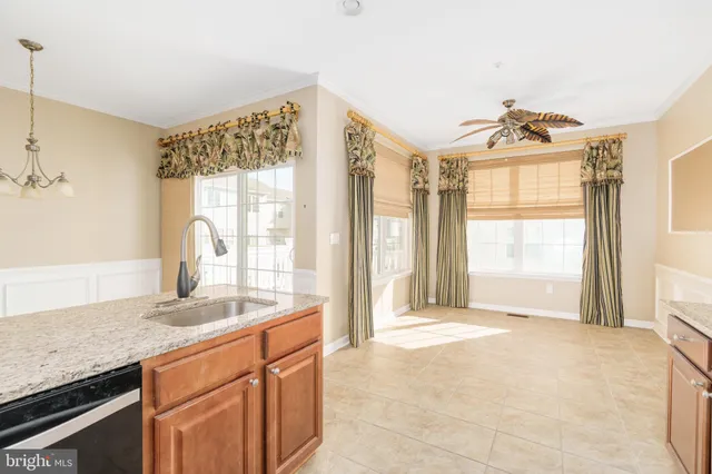 a spacious bathroom with a granite countertop sink and a large mirror