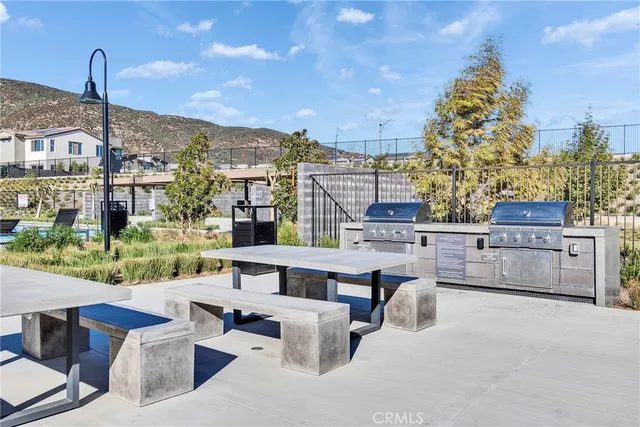 a roof deck with couches and potted plants