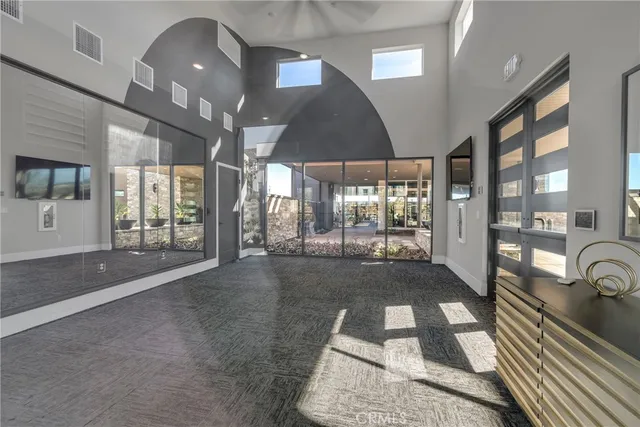 a room with lots of windows and glass door