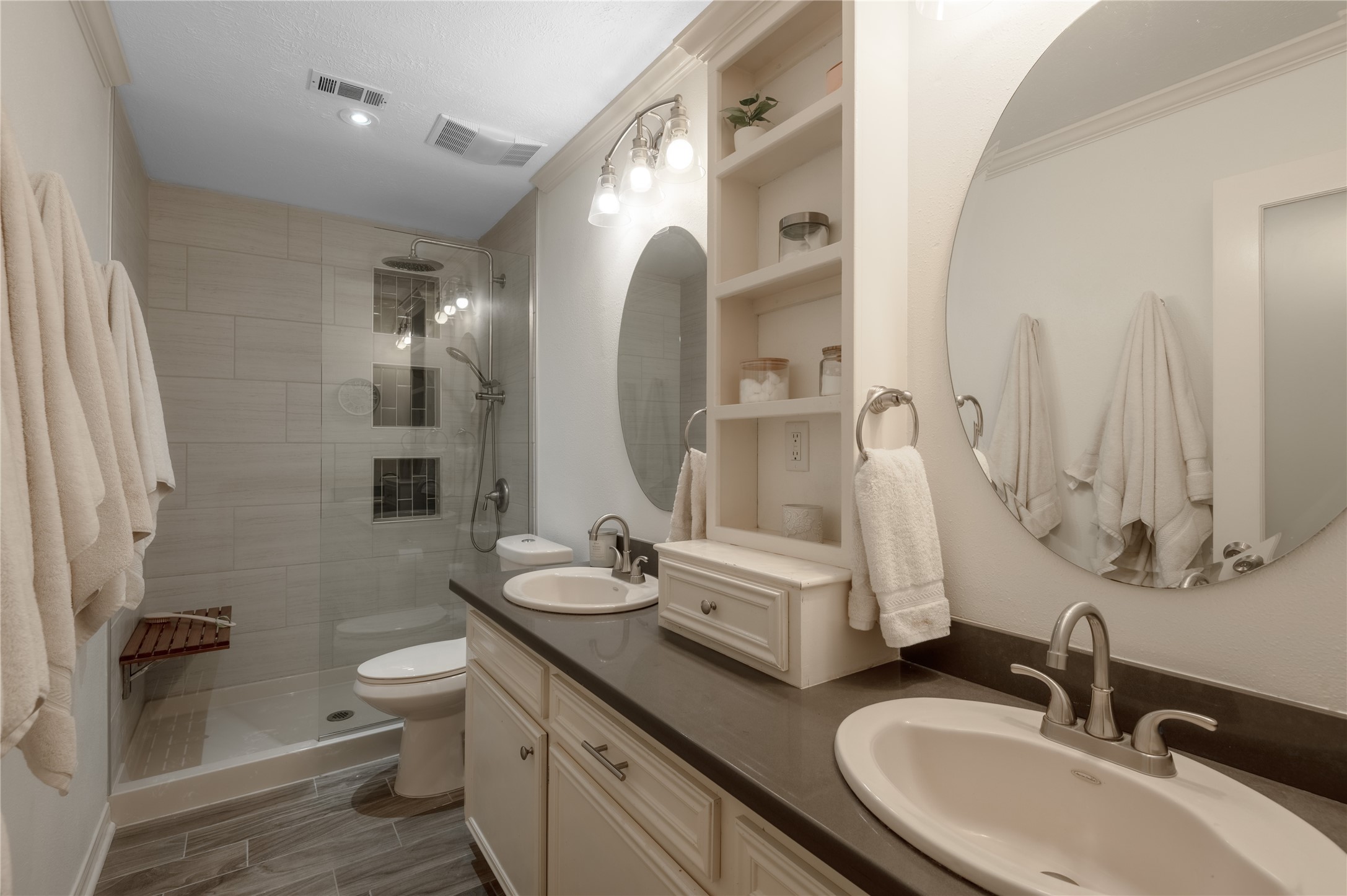 758 Wire Road Huntsville, TX 77320 - Photo 9 of 44 a bathroom with a double vanity sink toilet and shower