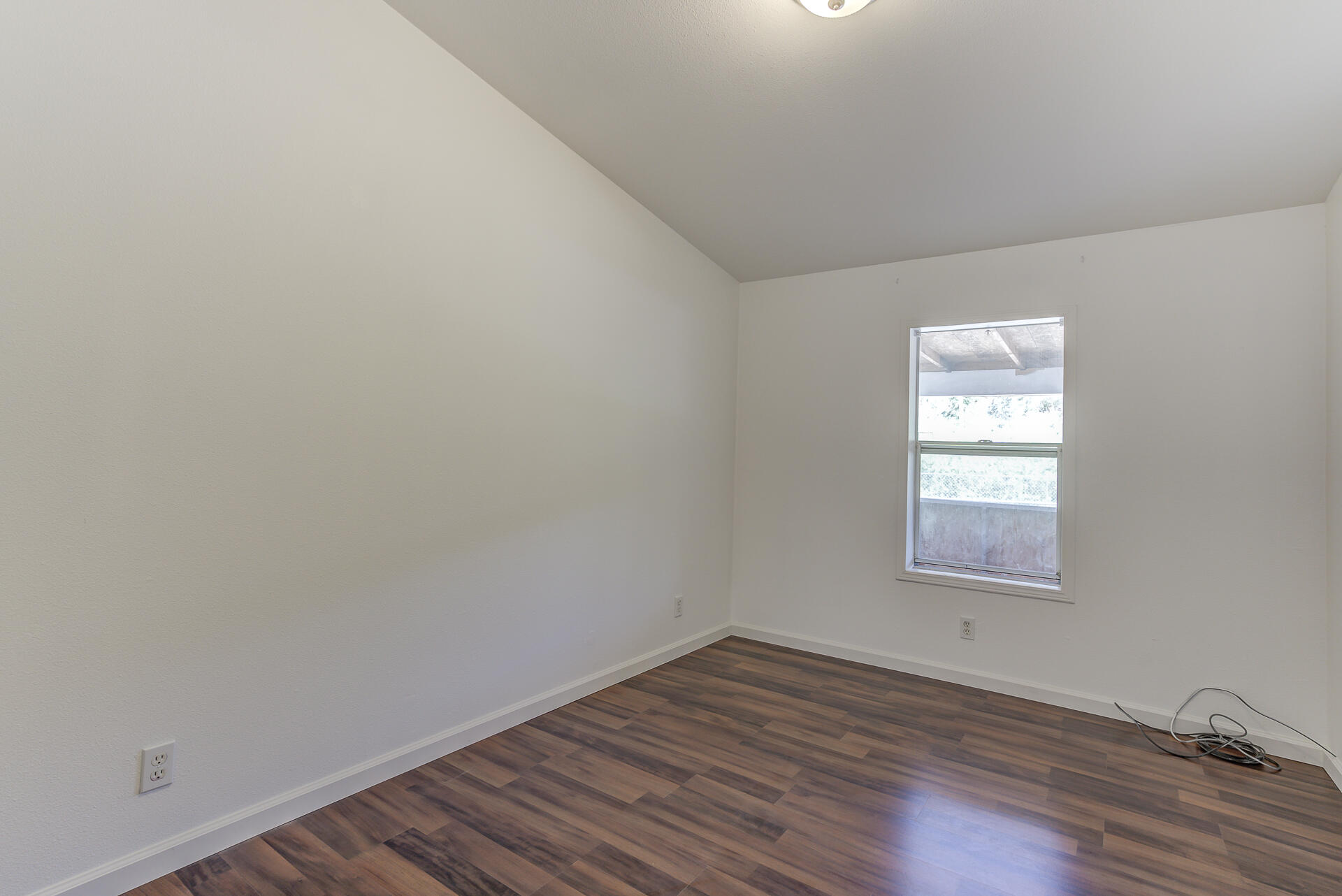 13905 Trinity Mountain Road, Unit CLEAR CREEK MOBILE PARK French Gulch, CA 96033 - Photo 17 of 24 an empty room with wooden floor and windows