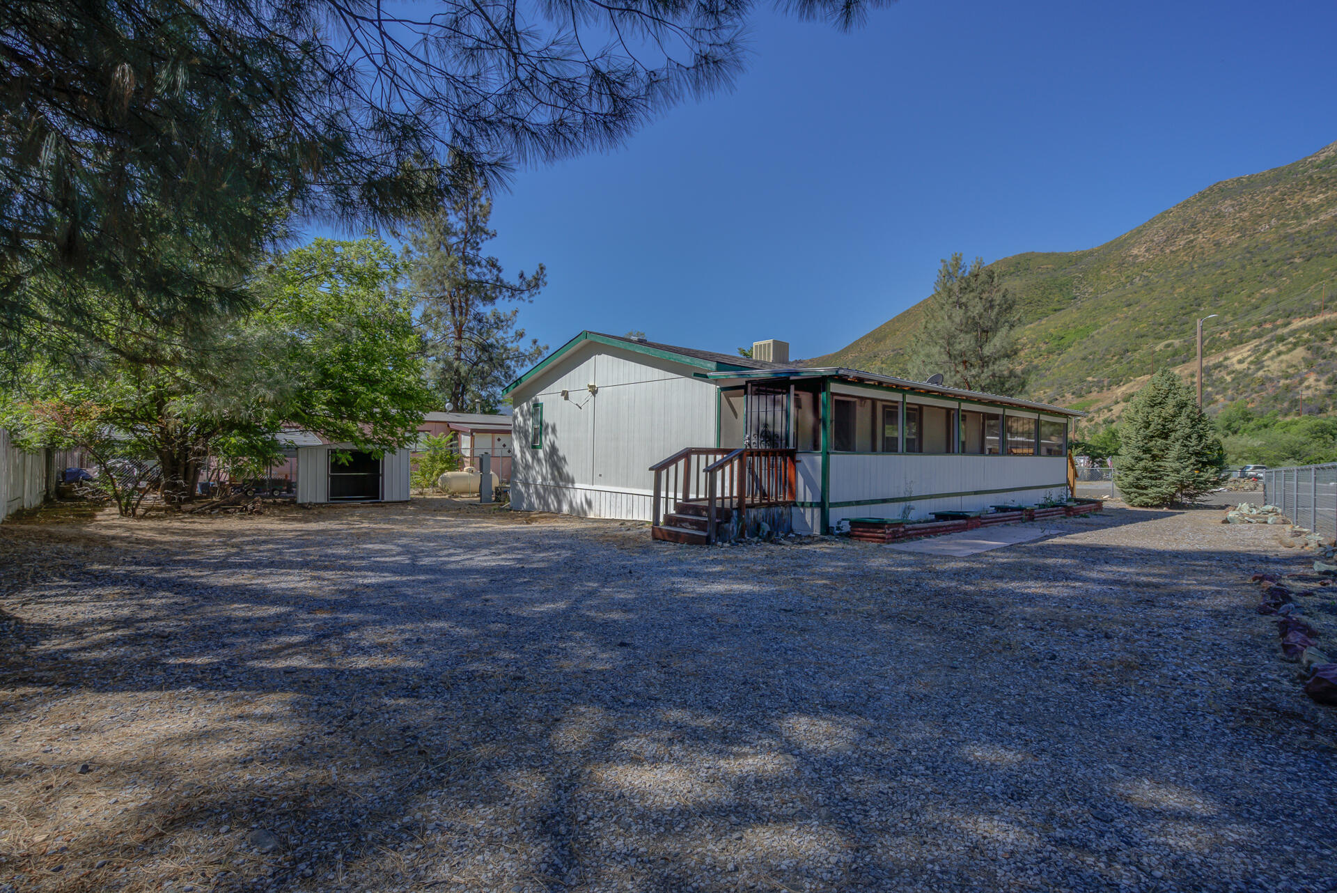 13905 Trinity Mountain Road, Unit CLEAR CREEK MOBILE PARK French Gulch, CA 96033 - Photo 4 of 24 a view of house with backyard and tree
