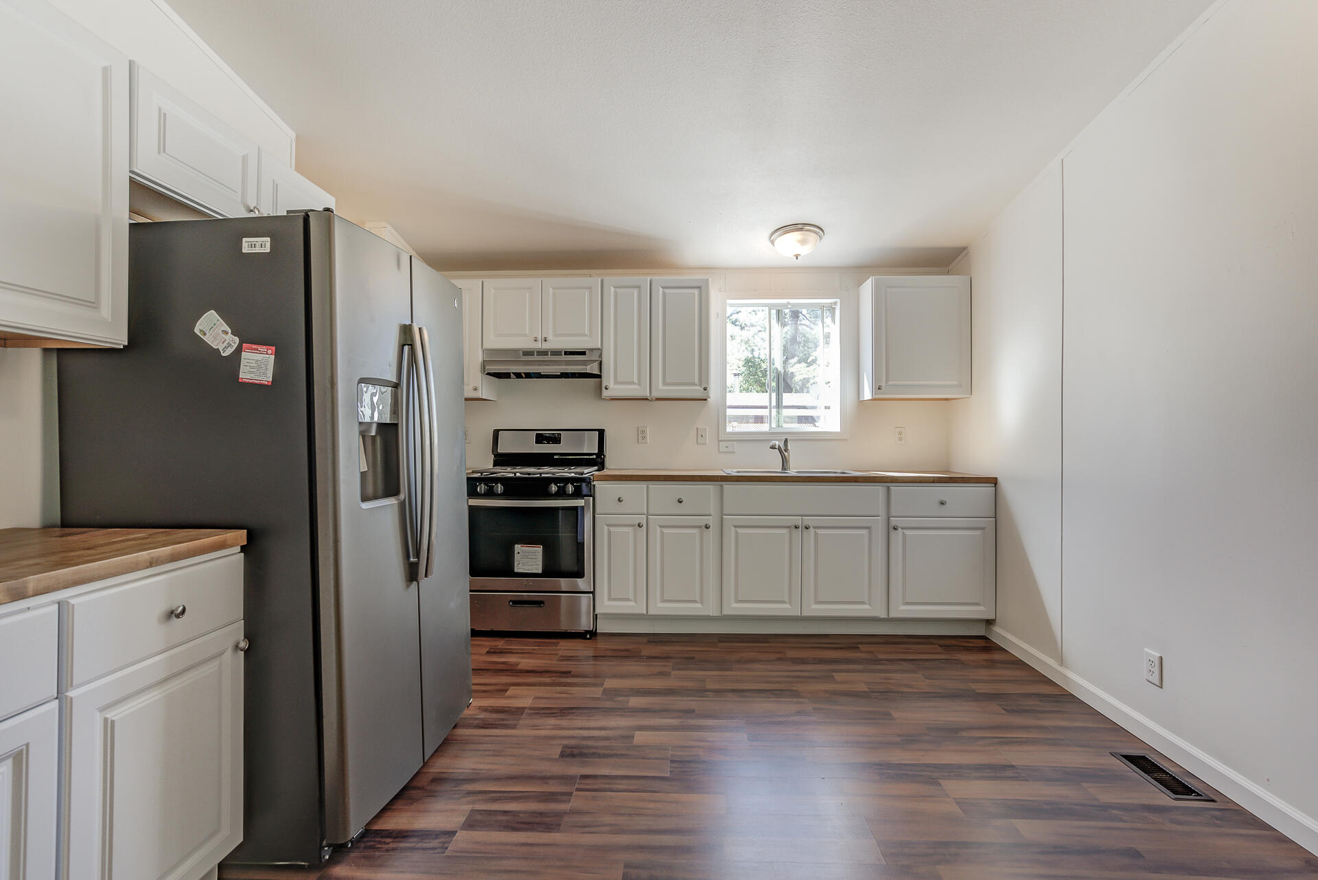 13905 Trinity Mountain Road, Unit CLEAR CREEK MOBILE PARK French Gulch, CA 96033 - Photo 8 of 24 a kitchen with a refrigerator and a stove top oven