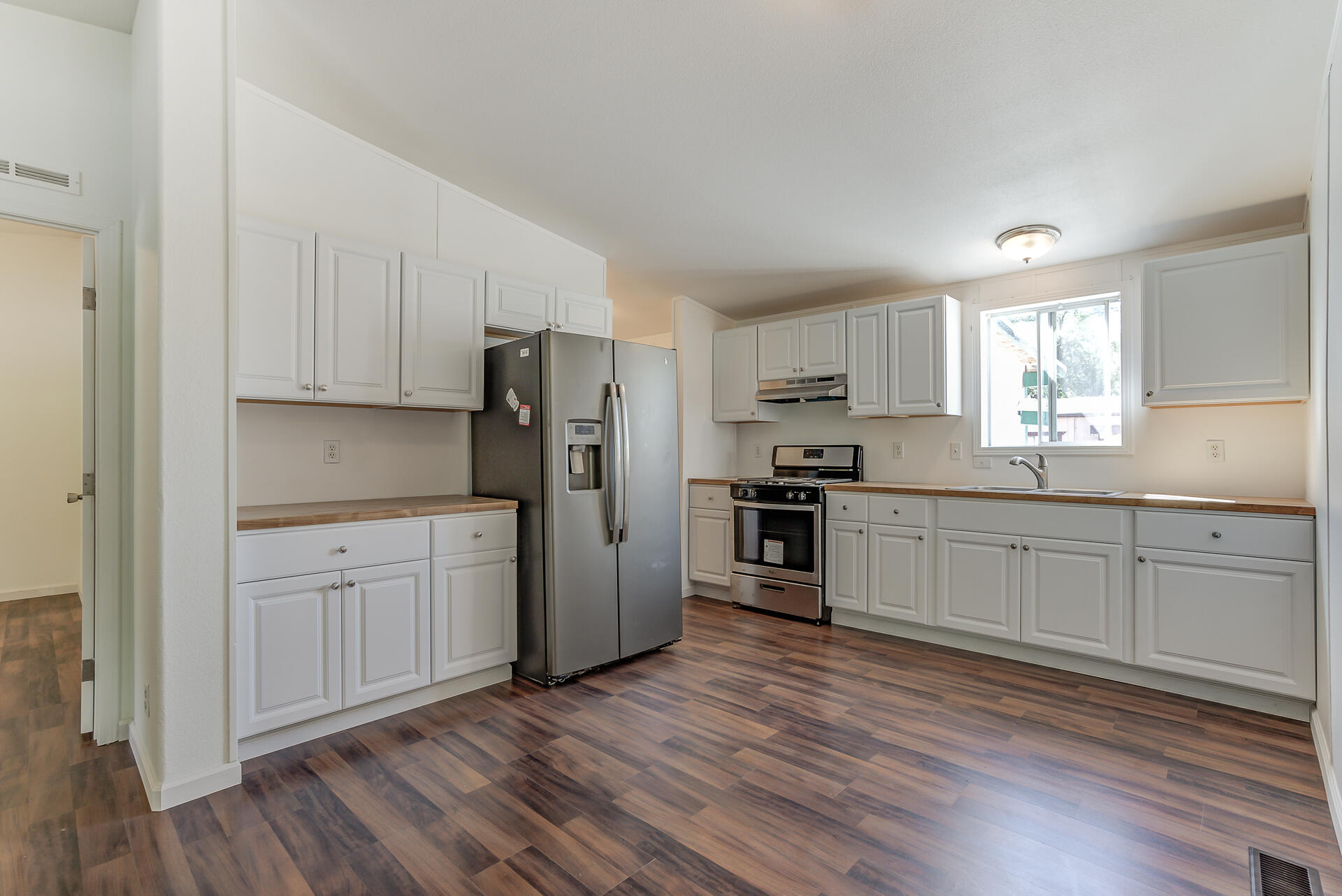 13905 Trinity Mountain Road, Unit CLEAR CREEK MOBILE PARK French Gulch, CA 96033 - Photo 9 of 24 a kitchen with granite countertop white cabinets and stainless steel appliances