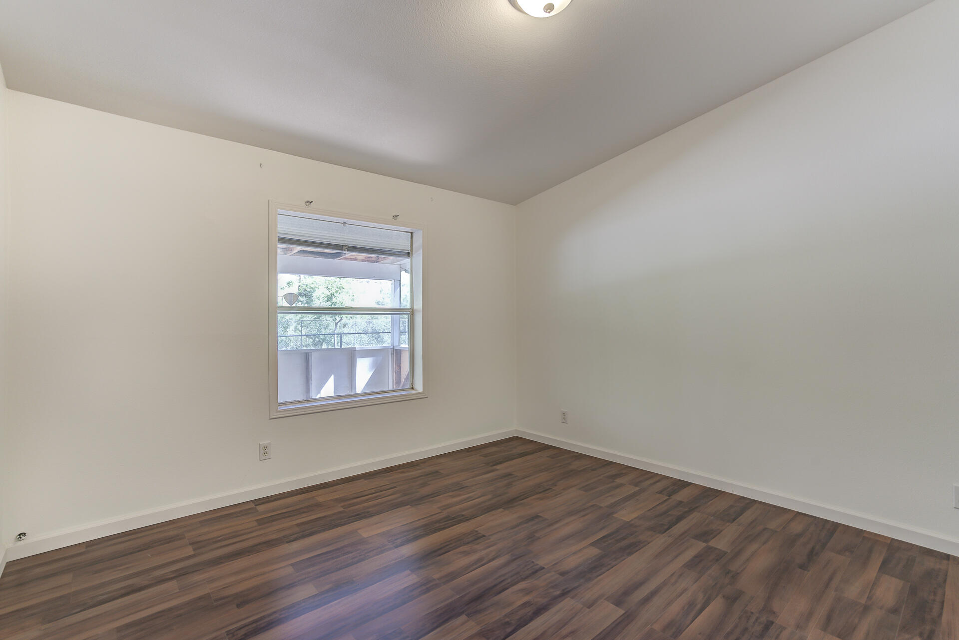 13905 Trinity Mountain Road, Unit CLEAR CREEK MOBILE PARK French Gulch, CA 96033 - Photo 10 of 24 an empty room with wooden floor and windows