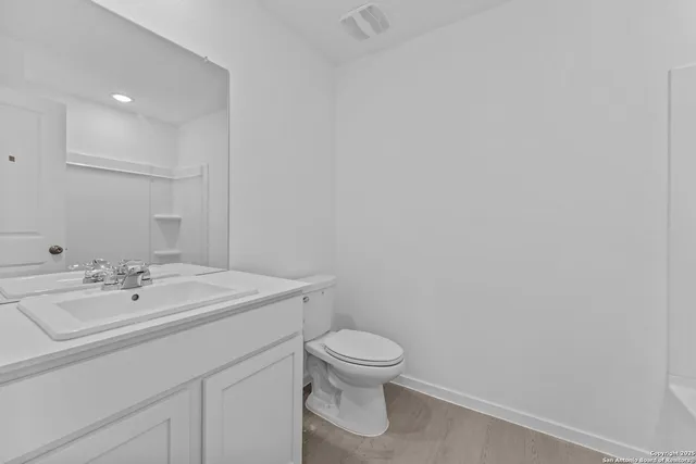 a bathroom with a sink a toilet and mirror