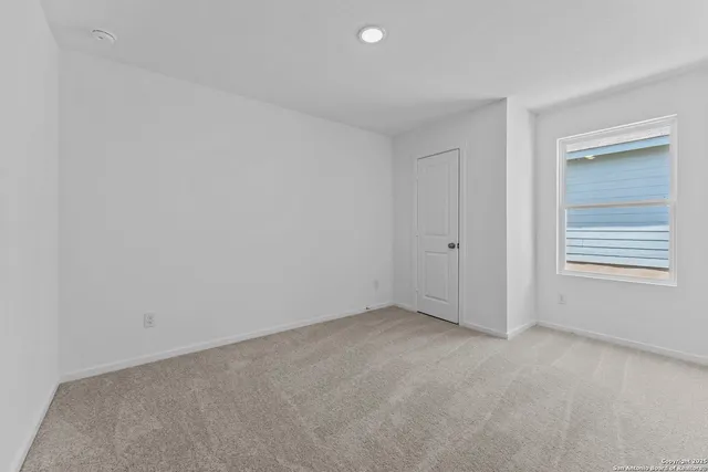 a view of an empty room and a window