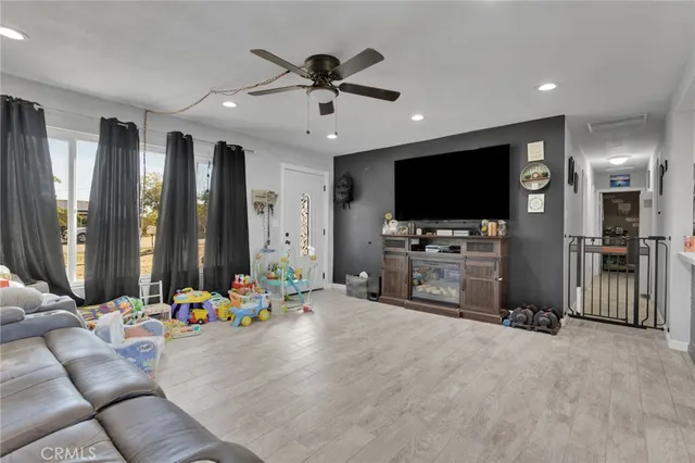 a view of a livingroom with furniture and a flat screen tv