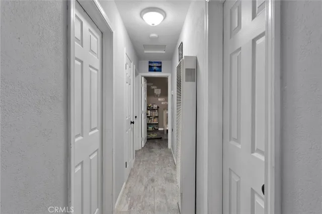 a view of a hallway with wooden shelves