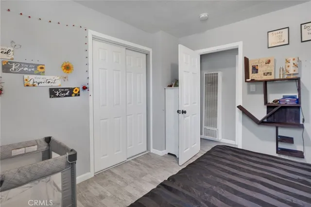 a view of a kitchen with fridge and wooden floor