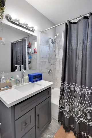 a bathroom with a double vanity sink mirror and shower